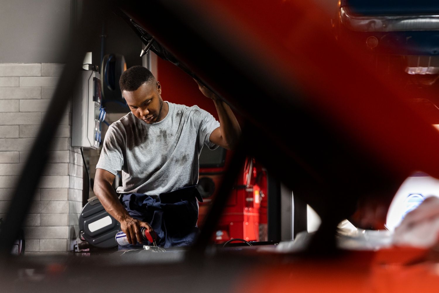 Velocity Auto Body mechanic working under the hood